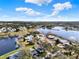 Beautiful aerial view of lakeside community under a bright blue sky with fluffy white clouds at 5338 Tigers Tail, Leesburg, FL 34748