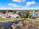 Aerial view showcasing the neighborhood's layout and proximity to a natural pond at 5338 Tigers Tail, Leesburg, FL 34748