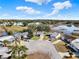 Aerial view of a residential neighborhood and nearby body of water, with well-maintained lawns at 5338 Tigers Tail, Leesburg, FL 34748