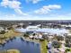 Scenic aerial view of a charming lakeside community, with lush greenery and homes nestled near the water at 5338 Tigers Tail, Leesburg, FL 34748