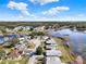 Aerial view of a well-maintained residential neighborhood near a lake on a sunny day at 5338 Tigers Tail, Leesburg, FL 34748