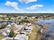 Aerial view of a well-maintained residential neighborhood near a lake on a sunny day at 5338 Tigers Tail, Leesburg, FL 34748