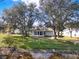 The property has a beautiful, expansive backyard with lush lawn and mature trees at 5338 Tigers Tail, Leesburg, FL 34748