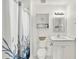 Bright bathroom with white vanity and cabinets, accompanied by an elegantly framed mirror and modern lighting at 5338 Tigers Tail, Leesburg, FL 34748