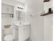 Bright white bathroom with ample storage, decorative mirror, and modern light fixture at 5338 Tigers Tail, Leesburg, FL 34748