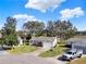 Well-maintained single-story home features a manicured front lawn and a paved driveway leading to an attached garage at 5338 Tigers Tail, Leesburg, FL 34748