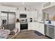 Well-lit kitchen with stainless steel appliances, white cabinets, and eat-in nook at 5338 Tigers Tail, Leesburg, FL 34748