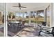 This sunroom features an outdoor view, comfortable seating, and a ceiling fan for added comfort at 5338 Tigers Tail, Leesburg, FL 34748