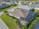 Aerial view showcases the home's layout and screened pool within a landscaped community at 5424 Donahe Path, The Villages, FL 32163