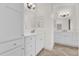 Bright white bathroom with double vanity, quartz countertop, undermount sinks, and modern fixtures at 5424 Donahe Path, The Villages, FL 32163