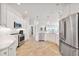 Bright kitchen featuring white cabinetry, stainless steel appliances, and stylish pendant lighting at 5424 Donahe Path, The Villages, FL 32163