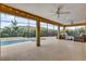 Inviting pool with a screened-in patio featuring comfortable outdoor furniture and tropical landscaping at 5424 Donahe Path, The Villages, FL 32163