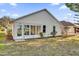 House exterior showcasing a sunroom addition and yard at 5513 Shriver St, Leesburg, FL 34748