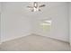 Comfortable bedroom featuring neutral walls, carpet, ceiling fan, and natural light from a window at 7260 Draper Ave, The Villages, FL 34762