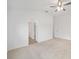 A secondary bedroom with neutral carpet, white walls, ceiling fan and attached closet at 7260 Draper Ave, The Villages, FL 34762