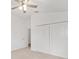 Bedroom with white walls, neutral carpet, ceiling fan, and closet with sliding doors at 7260 Draper Ave, The Villages, FL 34762