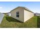 Side exterior view of a home with a well-kept lawn at 7260 Draper Ave, The Villages, FL 34762