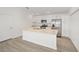 Well-lit kitchen with stainless steel appliances, center island, and white cabinetry at 7260 Draper Ave, The Villages, FL 34762