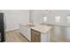 Kitchen island featuring a stainless steel dishwasher and double sink at 7260 Draper Ave, The Villages, FL 34762