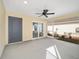 Enclosed patio showing a ceiling fan, gray door to house and glass door to outdoor screened porch at 7260 Draper Ave, The Villages, FL 34762