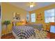 Charming bedroom with twin beds, playful decor, and natural light from the windows at 752 Chacall Loop, Mount Dora, FL 32757