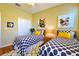 Bright bedroom with twin beds, patterned rugs, a closet, and colorful artwork at 752 Chacall Loop, Mount Dora, FL 32757