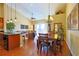 Dining area open to the kitchen and living room, featuring hardwood floors and natural light at 752 Chacall Loop, Mount Dora, FL 32757