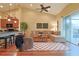 Bright living room featuring a ceiling fan, a sectional sofa, and sliding glass doors to the outside at 752 Chacall Loop, Mount Dora, FL 32757