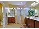 Bright main bathroom with double sinks, a glass-enclosed shower, and modern fixtures at 752 Chacall Loop, Mount Dora, FL 32757