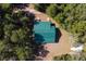 Aerial view of a home featuring a distinct green roof nestled in a wooded setting at 775 Abeble Rd, Lady Lake, FL 32159