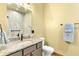 Bathroom featuring granite counters, toilet, and a framed mirror at 775 Abeble Rd, Lady Lake, FL 32159