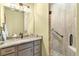 Bathroom featuring granite counters, unique stone shower floor and glass enclosed shower at 775 Abeble Rd, Lady Lake, FL 32159