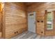 Charming wood paneled entryway featuring a transom windowed front door and stylish flooring at 775 Abeble Rd, Lady Lake, FL 32159