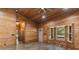 Wood-paneled living room featuring a bay window and a charming front door at 775 Abeble Rd, Lady Lake, FL 32159