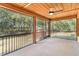 Spacious screened porch with wood ceiling and ceiling fan overlooking the trees at 775 Abeble Rd, Lady Lake, FL 32159