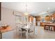 Charming dining area with white table and chairs, adjacent to kitchen at 819 Bolivar St, The Villages, FL 32159