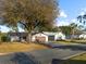 Single story home with brown garage door and paved driveway at 819 Bolivar St, The Villages, FL 32159