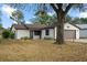 Single story home with brown garage door and paved driveway at 819 Bolivar St, The Villages, FL 32159