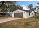 White single story home with brown garage door and paved driveway at 819 Bolivar St, The Villages, FL 32159