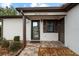 Front entry with glass door and brick walkway at 819 Bolivar St, The Villages, FL 32159