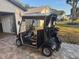 Black golf cart with tan seats and top at 819 Bolivar St, The Villages, FL 32159