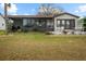 House exterior featuring a patio and screened enclosure at 819 Bolivar St, The Villages, FL 32159