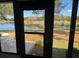 View of patio and lake from inside the house at 819 Bolivar St, The Villages, FL 32159