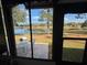 View of patio and lake from inside the house at 819 Bolivar St, The Villages, FL 32159