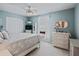 Bright bedroom featuring a white bed, closet, dresser, and calming blue walls with plenty of natural light at 8662 Se 133Rd Ln, Summerfield, FL 34491