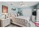 Bedroom with a white bed, a ceiling fan, and white furniture against calming blue walls at 8662 Se 133Rd Ln, Summerfield, FL 34491