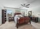 Comfortable bedroom with a ceiling fan, carpet flooring, and plenty of natural light from the windows at 8662 Se 133Rd Ln, Summerfield, FL 34491