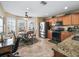 Bright kitchen with an eat-in area, stainless steel appliances, granite counters, and ample cabinetry at 8662 Se 133Rd Ln, Summerfield, FL 34491