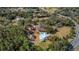 Bird's-eye view of house, pool, and surrounding area at 9210 County Road 48, Yalaha, FL 34797