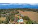 Expansive lakefront property with lush landscaping, pool, and a charming two-story farmhouse at 9210 County Road 48, Yalaha, FL 34797